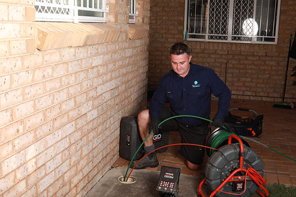 Joseph from The Brisbane Plumbers running a CCTV drain inspection at a Brisbane residential property