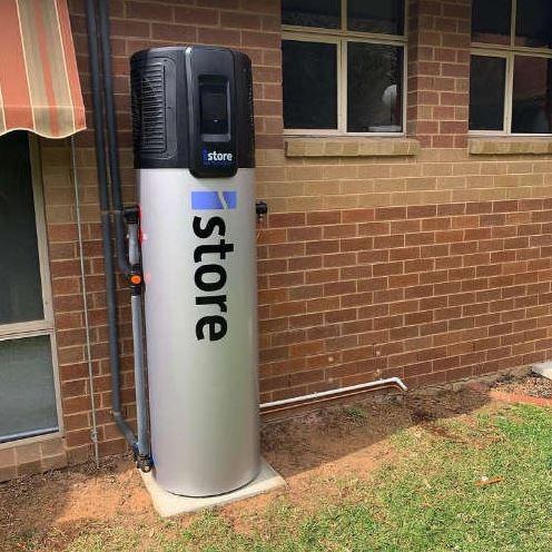 iStore heat pump hot water system installed outside a Brisbane home by The Brisbane Plumbers