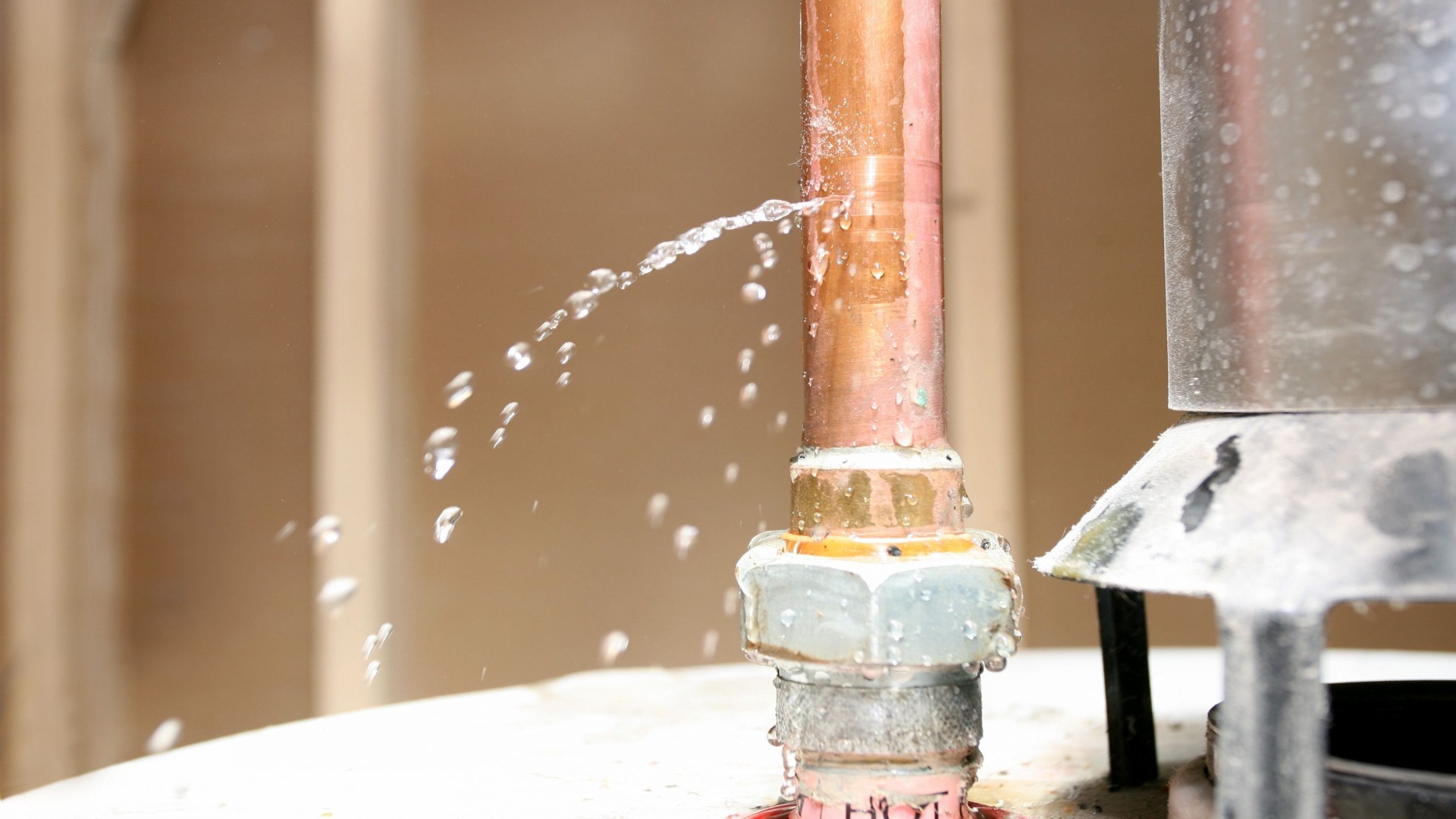 Leaking copper pipe joint spraying water inside a Brisbane home