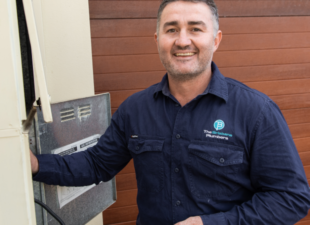 Joseph, Director of The Brisbane Plumbers, inspecting a gas hot water system at a Brisbane home