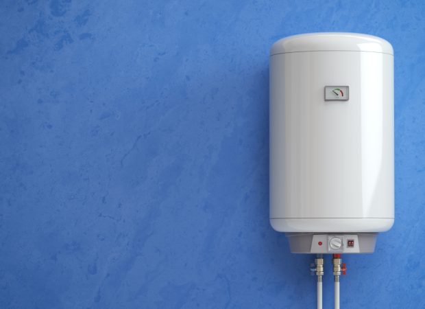 Electric hot water system tank mounted on a wall with temperature control and water pipe connections